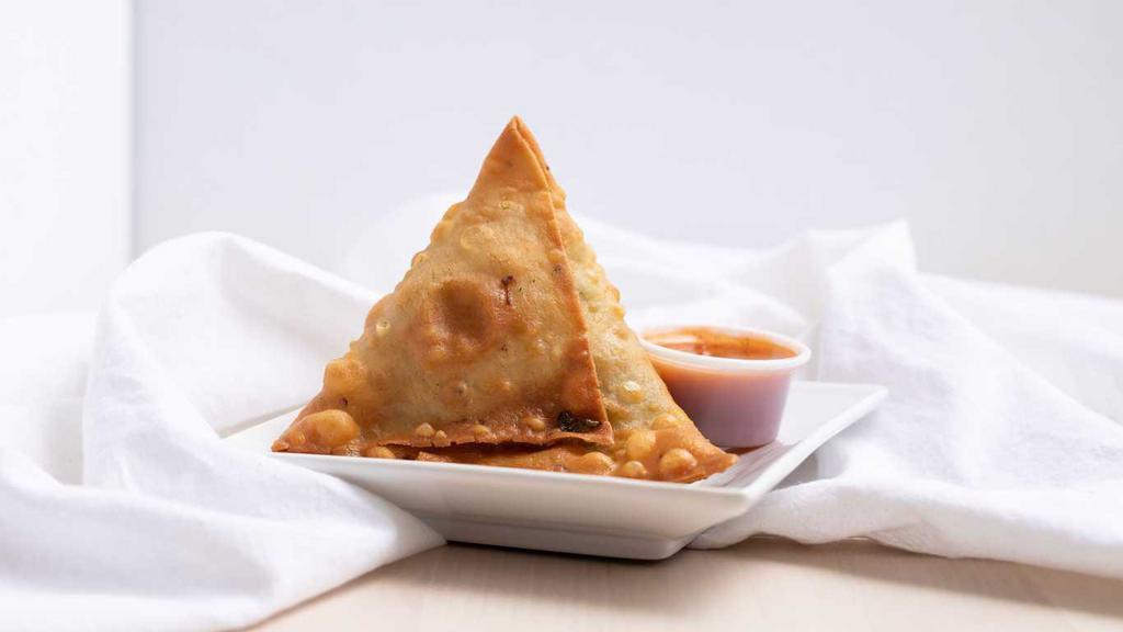 Chicken Samosa (1 Pcs) · Puffed pastry stuffed with ground chicken, green peas and house spices