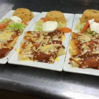 Enchiladas Supremas · Four rolled corn tortillas: one beef, one chicken, one cheese and one bean. Topped with our ...