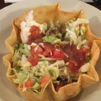 Taco Salad (Chicken Or Beef) · Crispy tortilla shell filled with chicken or beef topped with lettuce, tomato and sour cream.