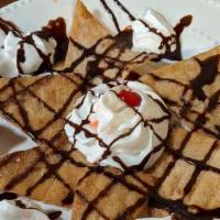 Sopapilla · Delicious crunchy flour tortillas covered with sugar and cinnamon. Topped with whipped cream.