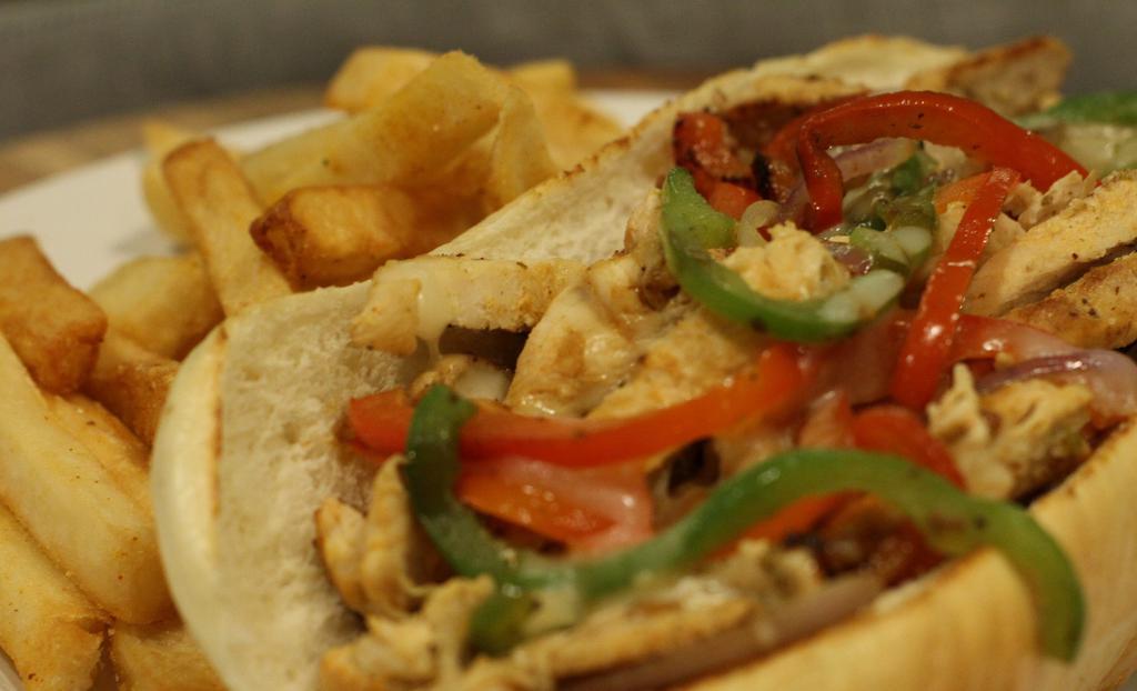 Chicken Philly Cheesesteak · Fresh & thinly sliced chicken breast grililled with peppers, onions, and mozzerella cheese Served on a hoagie roll with a side of fries.