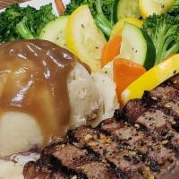New York Strip · Choice 14 oz cut of New York strip served with mashed potatoes and mixed vegetables.