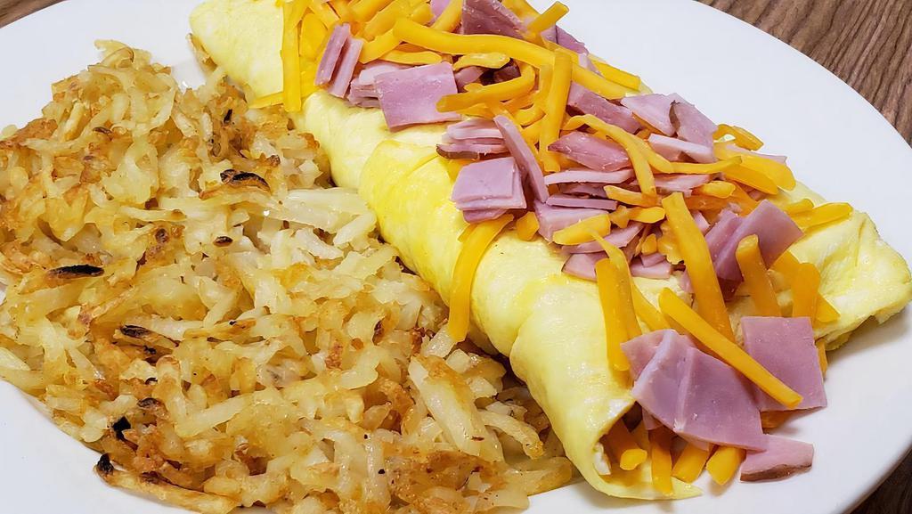 Ham & Cheese Omelet · Diced virginia ham and American cheese. Served with hashbrowns.