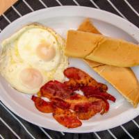 Manna Breakfast 1 · Two eggs fried or scramble with bacon with your choice of toast or latin toast with butter.