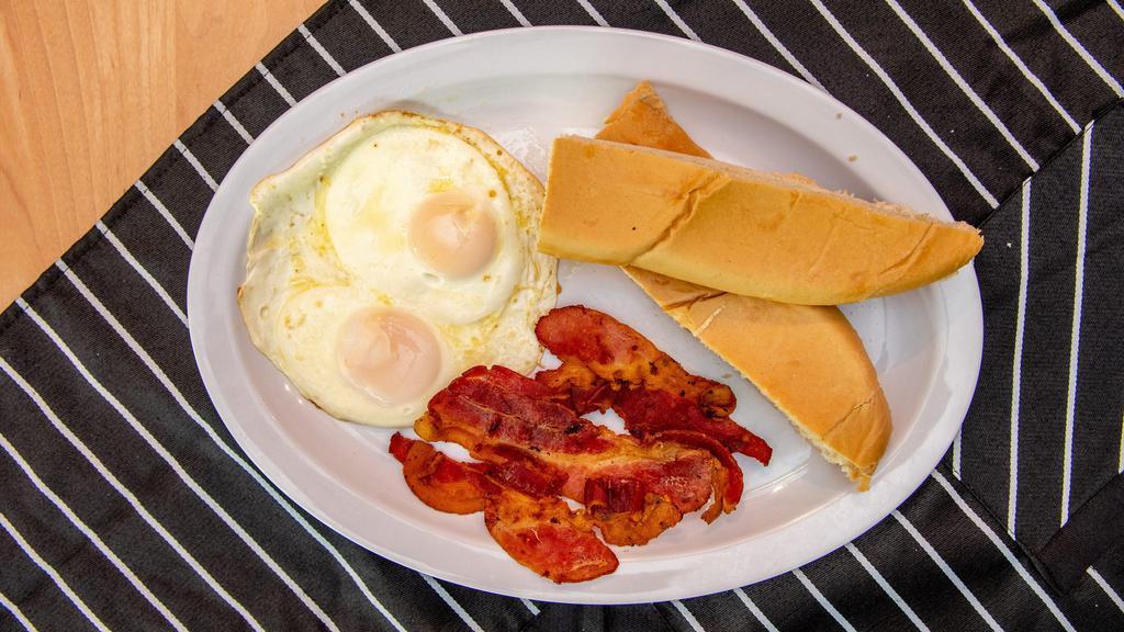 Manna Breakfast 1 · Two eggs fried or scramble with bacon with your choice of toast or latin toast with butter.