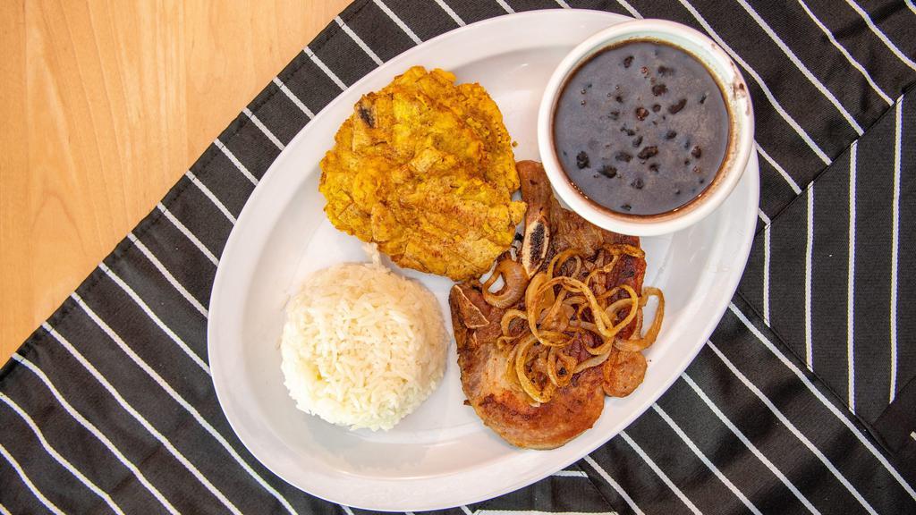 Manna Lunch 3 · Pork chop plater with a side  of rice and  beans and fried  plantains.