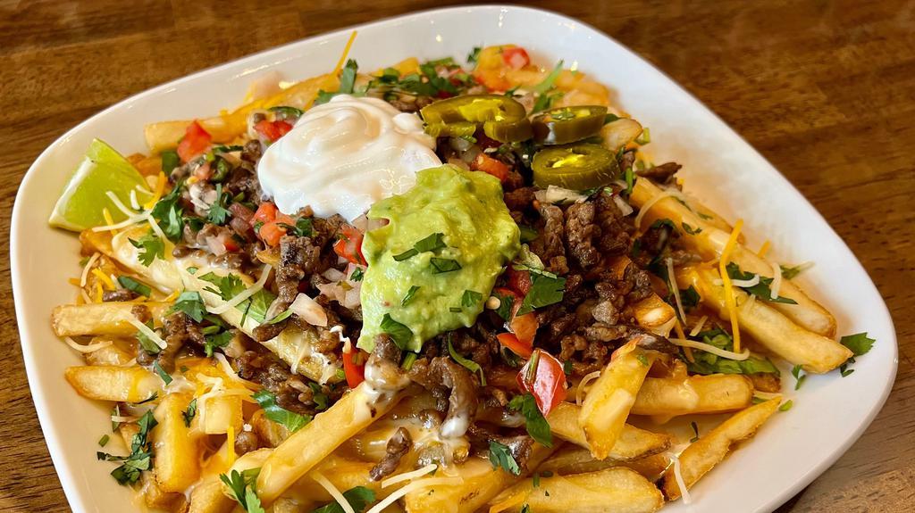 California Steak Fries · French fries topped with Mexican shredded cheese, melted queso, grilled steak, pico de gallo, guacamole, sliced jalapeño, and sour cream.