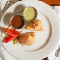 Punjabi Samosa · A triangular savory pastry containing spiced vegetables fried in oil.