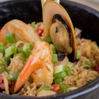 Seafood Chaufa · Seafood fried rice, soy sauce, scrambled eggs, red peppers, and green onions.