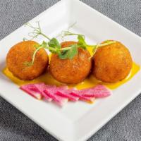Crab Risotto Croquettes · Crab, cream cheese, and chives saffron beurre blanc.