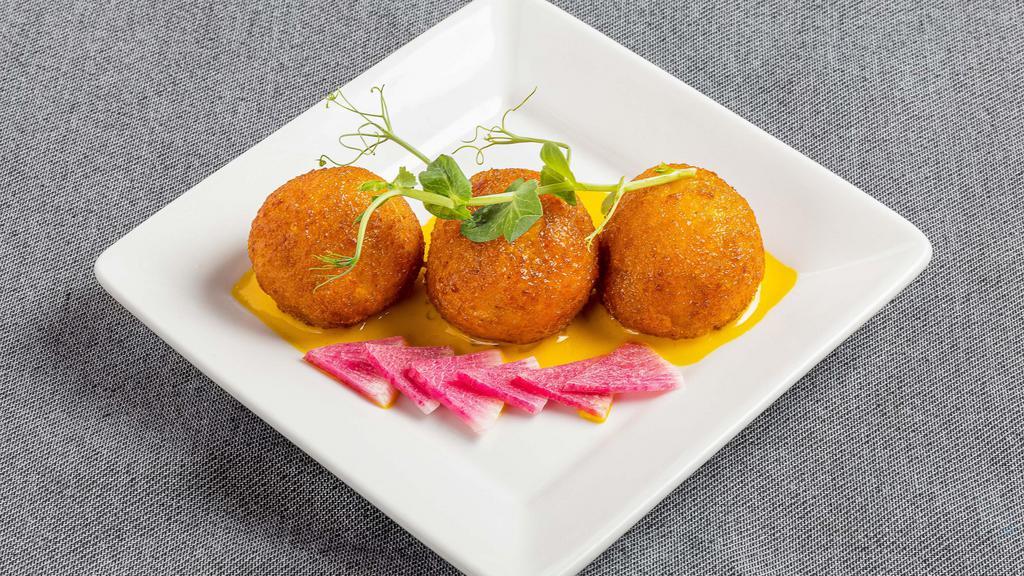 Crab Risotto Croquettes · Crab, cream cheese, and chives saffron beurre blanc.