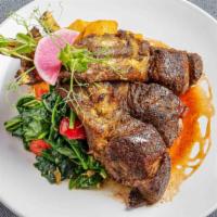 Spice Roasted Double-Cut Lamb Rib Chops · Spiced potatoes, garlic spinach, sumac gastrique, and mint oil.