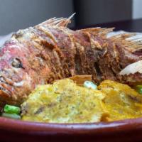 Pargo Entero Frito · Deep fried whole red snapper with two side.