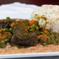 Seco De Carne Con Frejoles · Chunks of meat in a cilantro sauce served with white beans and white rice.