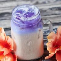 Iced Butterfly Chai · Hibiscus-infused chai and milk served over ice and topped with butterfly truth serum.