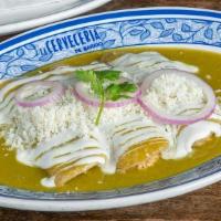 Enchilada Verde · Pulled chicken, Cotija Cheese, Mexican crema, Tomatillo Sauce, White Rice, Refried Black Beans