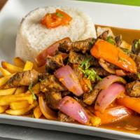Lomo Saltado · Angus Beef sautéed with our unique OHH Mar special seasoning, onions and tomatoes. Served wi...