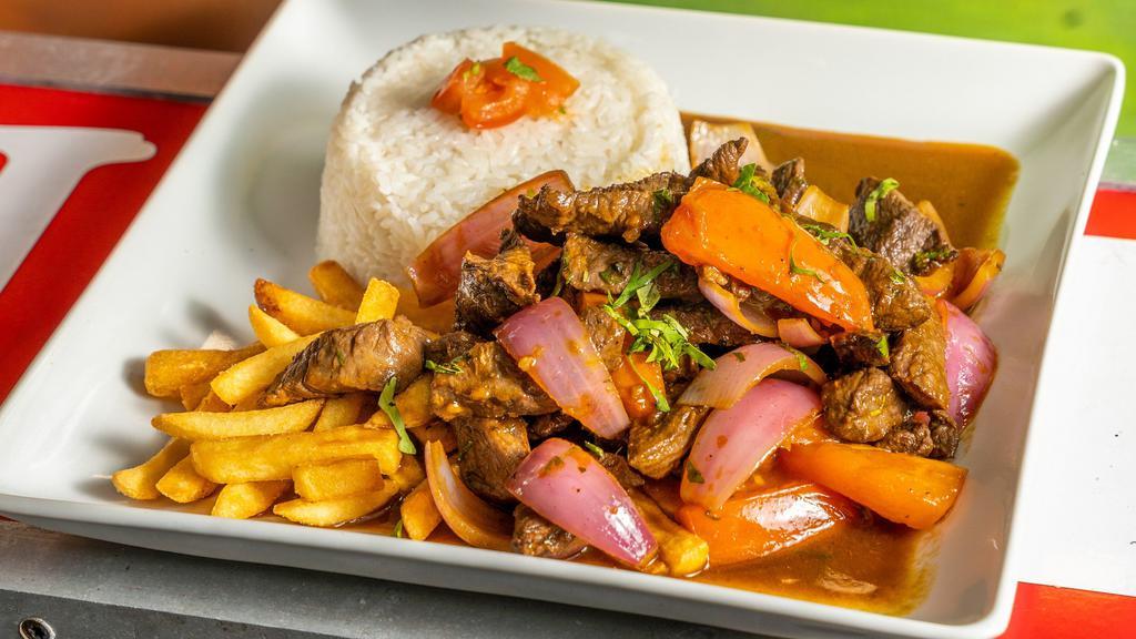 Lomo Saltado · Angus Beef sautéed with our unique OHH Mar special seasoning, onions and tomatoes. Served with French fries and white  rice.