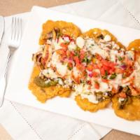 Chicken Tostones · Fried green plantains topped with grilled chicken, peppers, onions, mushrooms, green tomatil...