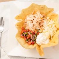 Taco Salad  · Large crispy flour tortilla shell filled with shredded chicken, ground beef or tinga. Lettuc...