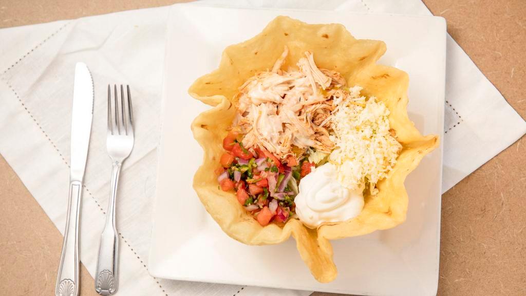 Taco Salad  · Large crispy flour tortilla shell filled with shredded chicken, ground beef or tinga. Lettuce, shredded cheese, sour cream, cheese sauce and pico de gallo.