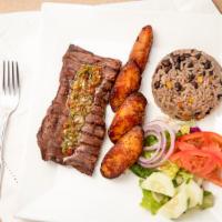 Churrasco Steak · Eight oz. of grilled steak topped with chimichurri sauce. Served with Moro rice, fried plant...