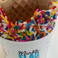 White Chocolate With Sprinkles Waffle Bowl · Homemade Waffle, Dipped in our Premium White Chocolate with Sprinkles