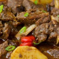 Curry Goat (Medium) · The meal is served with rice, sweet plantains, and one extra side. This delicious curry goat...