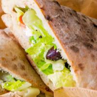 Greek Sandwich · Lettuce, tomatoes, feta, cucumber, red onions, kalamata olive, and greek dressing.