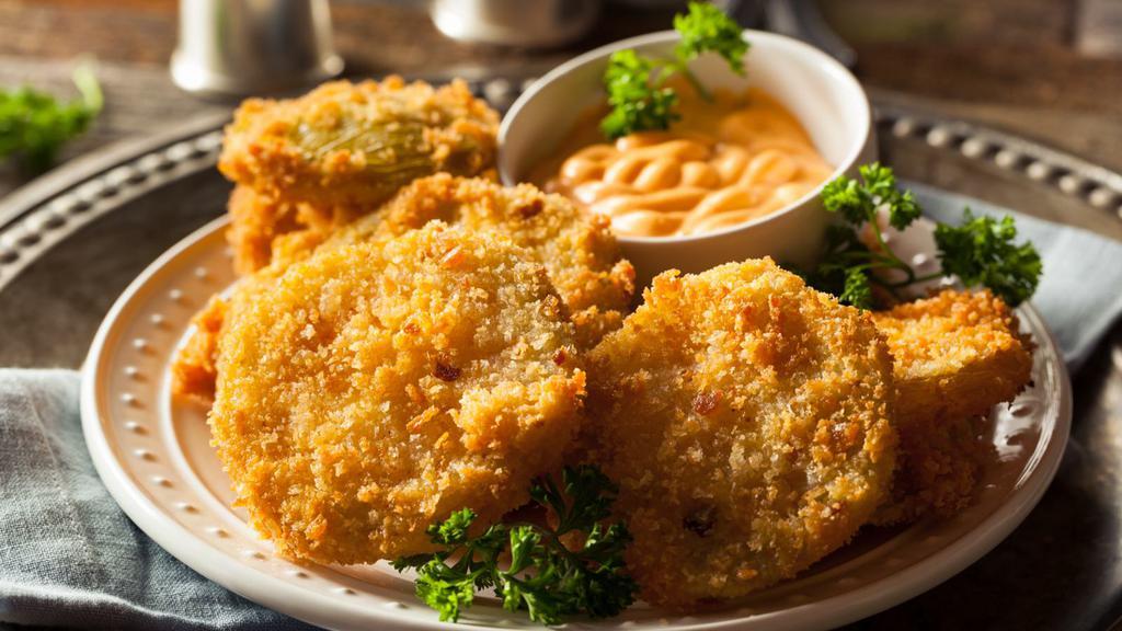 Fried Green Tomatoes · Three thick slices of breaded and golden fried, tangy green tomatoes.