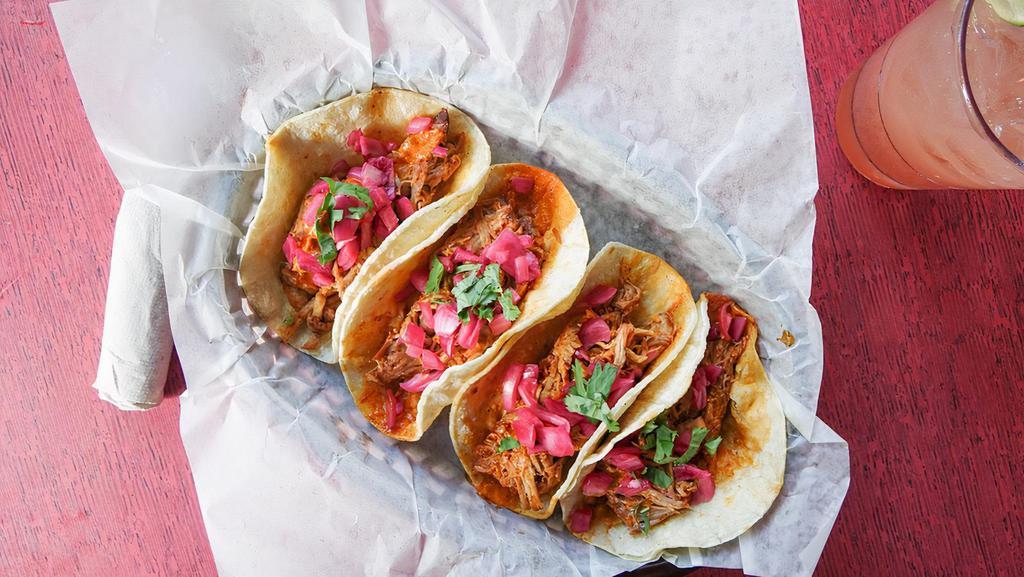 Pork Pibil Taco Plate · 3 tacos with ancho-citrus braised pork, pickled onion, cilantro, gluten friendly, choice of side