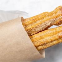 Churros · Mexican pastry coated with sugar.