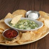 Spinach Artichoke Dip · A creamy blend of spinach, artichoke hearts and Italian cheeses. Served with tortilla chips,...