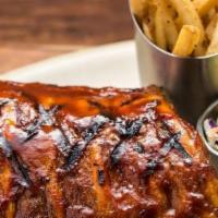 World-Famous Baby Back Ribs - Half Rack · Tender baby back ribs triple basted in Original BBQ Sauce. Served with your choice of side.