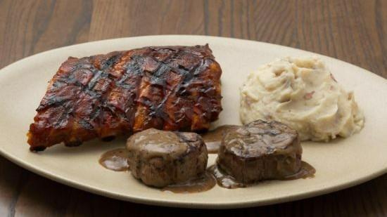Filet Medallions + Rib Combo · Two tender beef medallions topped with Cabernet demi-glace, and a half rack of our World-famous Baby Back ribs with Original sauce. Served with your choice of two sides.