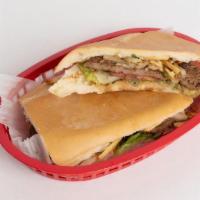 Pan Con Bistec · Seared Steak with, lettuce, tomatoes, potato Sticks ,and cooked onions