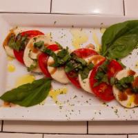 Caprese Salad · Fresh tomatoes and fresh mozzarella, basil and olive oil.