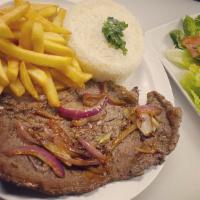 Steak Platter On The Grill · Grill steak with onions served with 2 sides