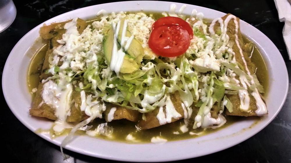 Enchiladas Verdes De Pollo (Hot) · Green spicy salsa filled with chicken and topped with lettuce, Mexican fresh cheese, sour cream and avocado