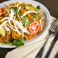 Chicken Biryani · Cooked with basmati rice and special biryani spices.