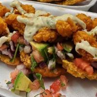 Rumba Chalaca · Crispy tostones topped with fresh onions, tomatoes, fresh lime, avocado, accompanied with fr...