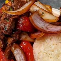 Lomo Saltado · 5 oz of Tenderloin cubes flambeed with red onion, tomatoes, and cilantro. Served with crispy...