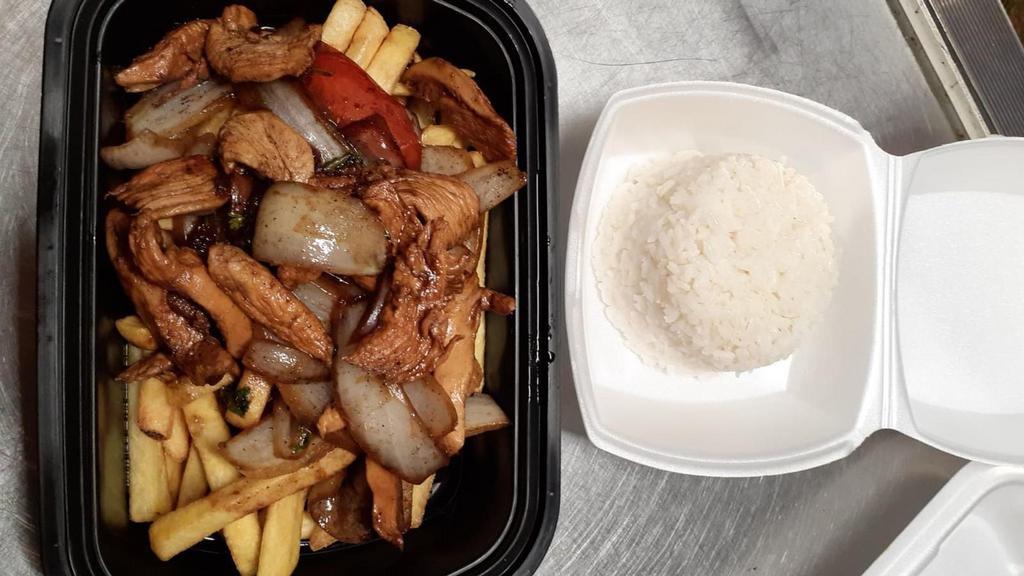 Saltado De Pollo · Chicken flambeed with red onion, tomatoes, and cilantro to create. Dishes of Peru accompanied by crispy French fries and white rice.