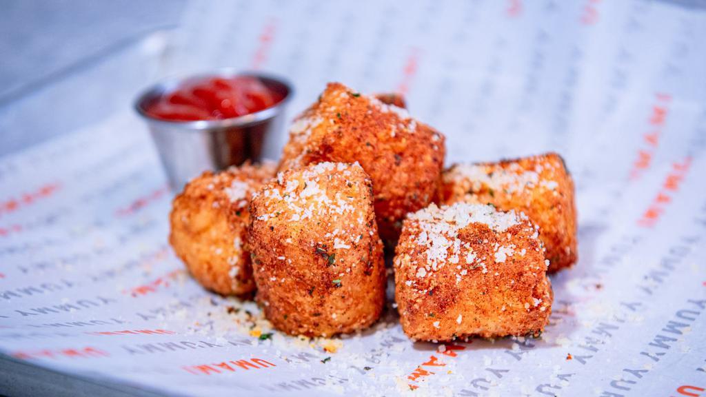 Cheesy Potato Tots · Hand breaded and deep fried potato tots filled with our signature three cheese blend, topped with parm cheese served with your choice of one sauce.