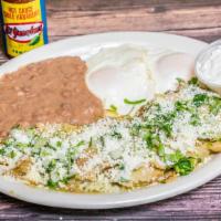 Chilaquiles Verdes O Rojas Con Huevo  · Red or green chile chilaquiles with fried eggs. Feeling hungry? Add our delicious steak.