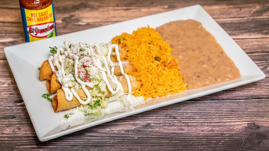 Falutas De Pollo Con Arroz Y Frijoles · Three fried rolled tortillas stuffed with chicken with rice and beans.