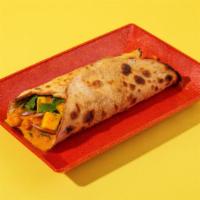 Chana Masala Roll · With sliced onions and your choice of chutney in a roti roll.