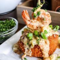 Shrimp Grit Cake · A decadent fried golden brown grit cake topped with jalapenos, white cheddar cheese, and a s...