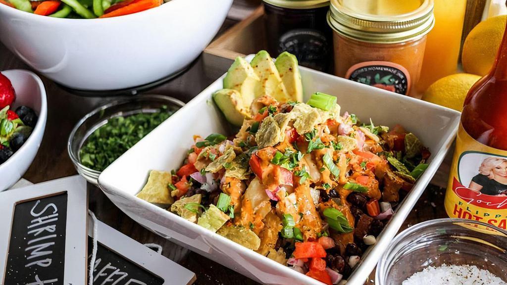 Black Bean Energy Bowl · Potatoes, green peppers, and onions, tofu, black bean salsa, avocado, drizzled with house-made vegan chipotle sauce, tortilla crumbles, green onions, and parsley.