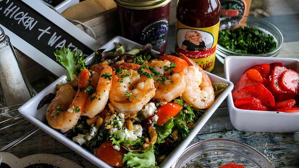 Fall Harvest Salad · Sitting on a bed of mixed greens served with feta cheese, dried cranberries, croutons, cherry tomatoes, fried onions served with sautéed shrimp.